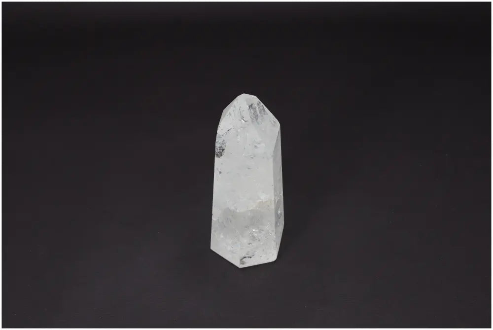 Lemurian Quartz Obelisk with healing properties, hand-selected and ethically sourced, enhancing energy and balance on a dark background.