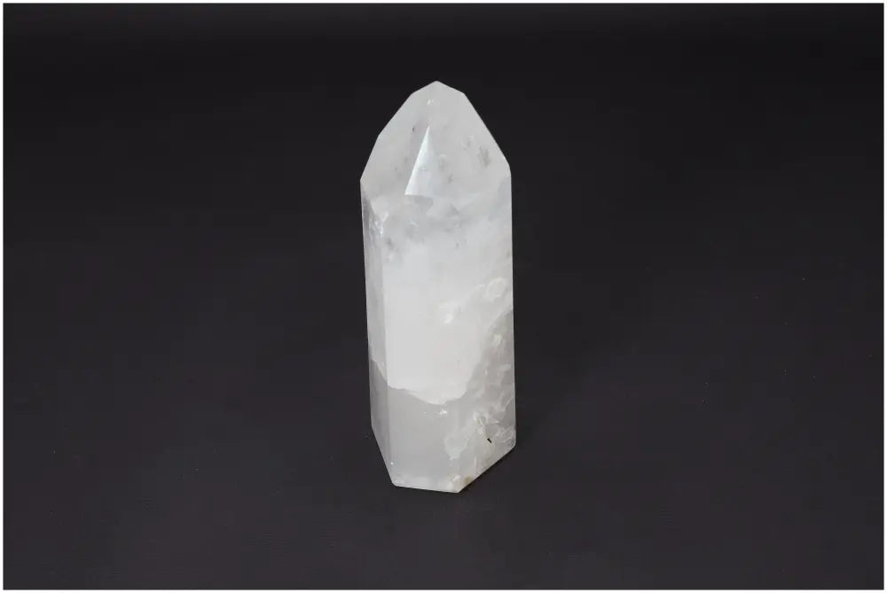 Lemurian Quartz Obelisk crystal on a dark background, known for clarity, balance, and personal growth, ethically sourced and hand-selected.