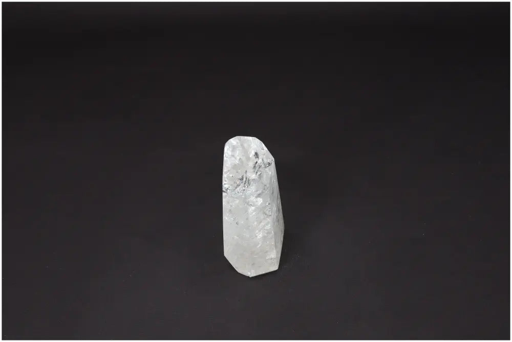 Lemurian Quartz Obelisk against a black background, showcasing its natural clear crystal formation and healing properties.