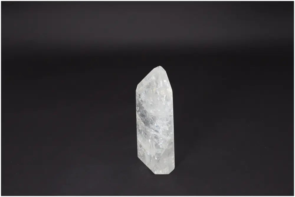 Lemurian Quartz Obelisk crystal on dark background, known for amplifying energy, enhancing clarity, and promoting personal growth.