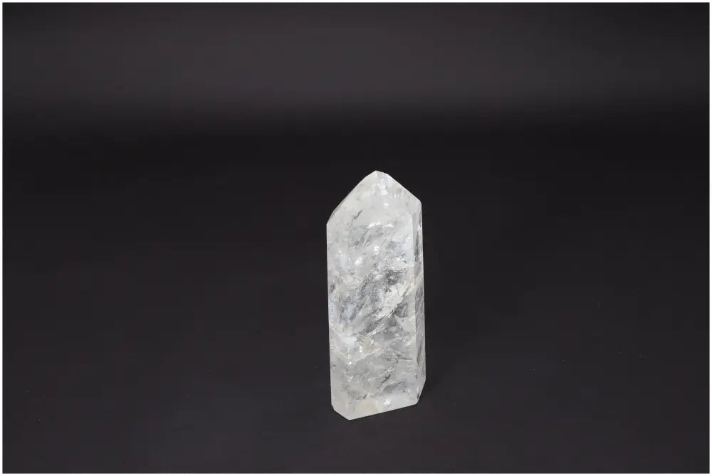 Lemurian Quartz Obelisk on black background, showcasing its clarity and natural formation for energy amplification and personal growth.