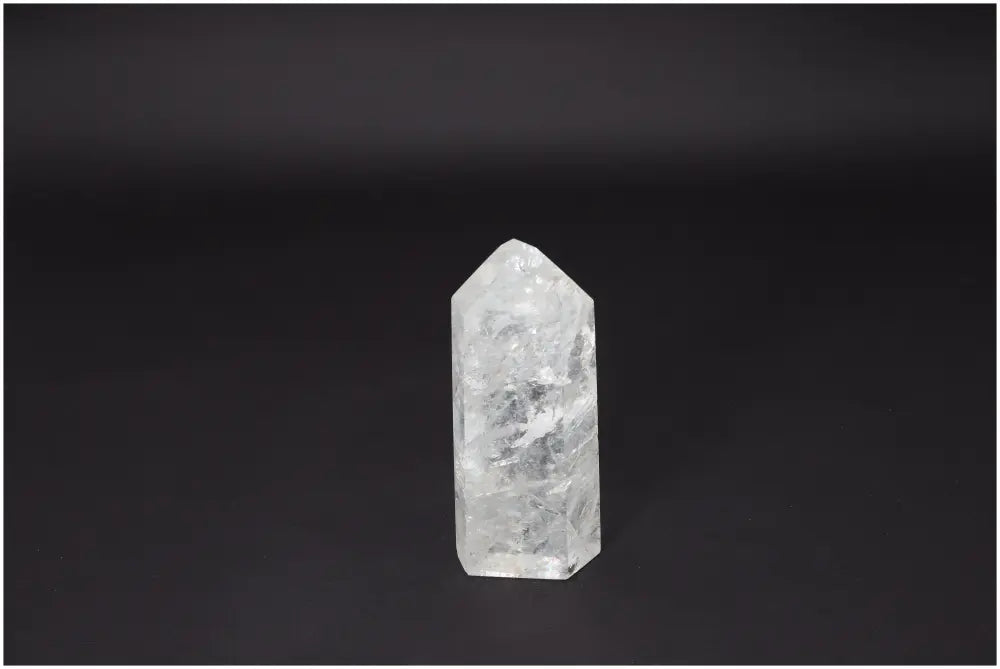 Lemurian Quartz Obelisk on a dark background, representing clarity and personal growth with its hand-selected, naturally formed crystal structure.