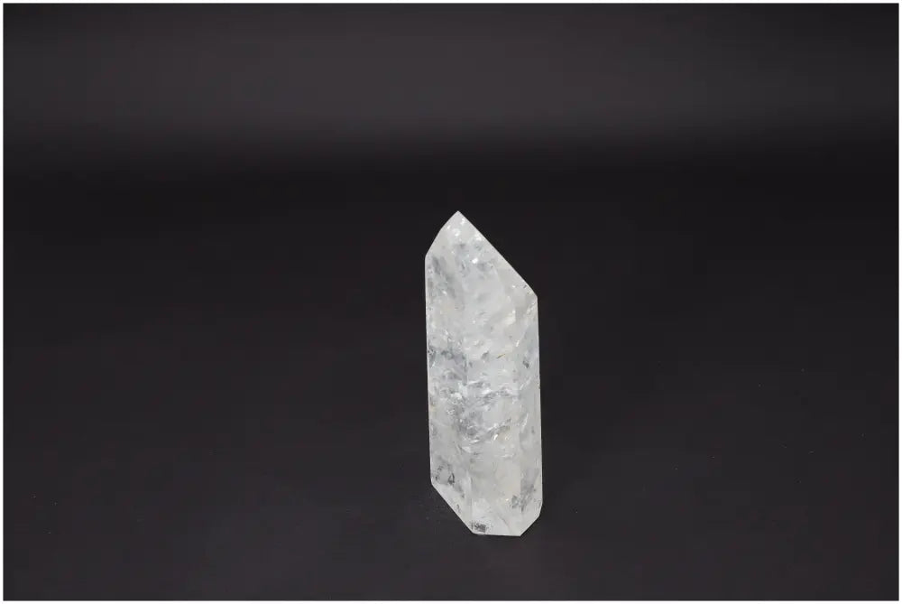 Lemurian Quartz Obelisk on dark background showcasing its clarity and natural formation, ideal for energy amplification and personal growth.