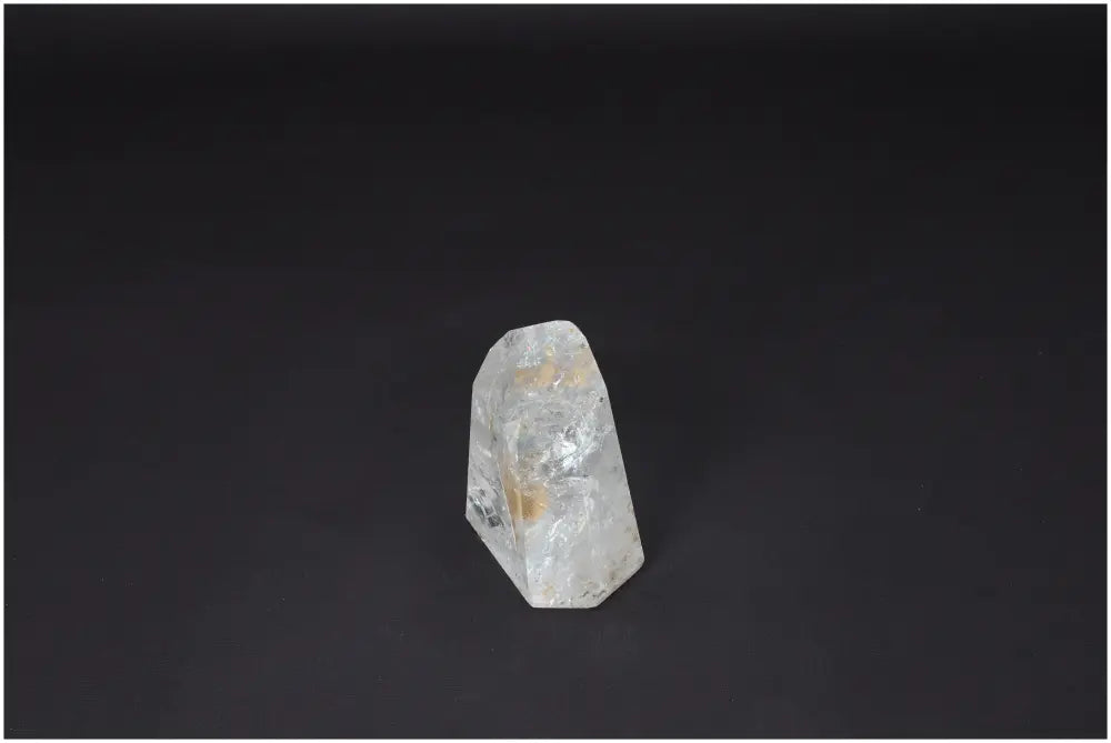 Lemurian Quartz Obelisk on a dark background, showcasing its clarity and natural form, ideal for energy amplification and personal growth.