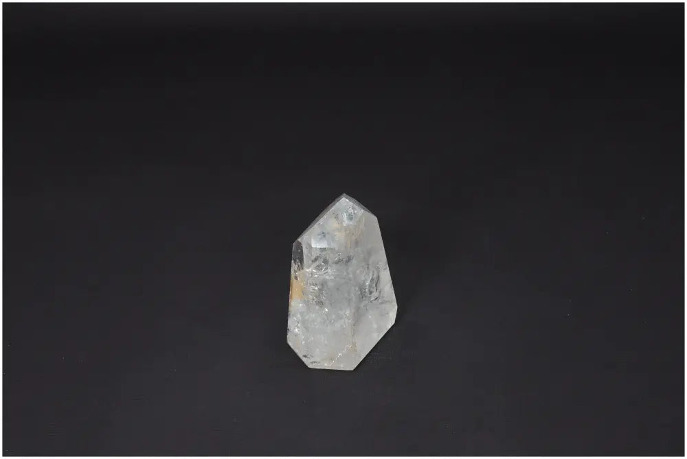 Lemurian Quartz Obelisk on dark background, emphasizing its natural clarity and ethereal beauty, ideal for clarity and personal growth.