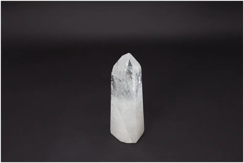 Lemurian Quartz Obelisk on black background, showcasing its clear, crystal formation and healing properties for clarity and balance.