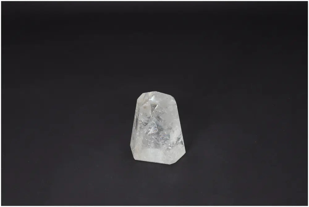 Lemurian Quartz Obelisk crystal on a dark background, known as a "Master Healer," amplifying energy and promoting clarity and balance.