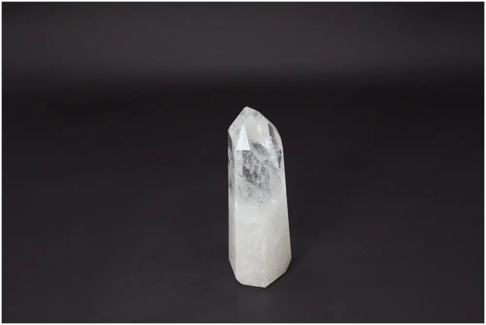Lemurian Quartz Obelisk Crystal for clarity and balance displayed against a dark background.