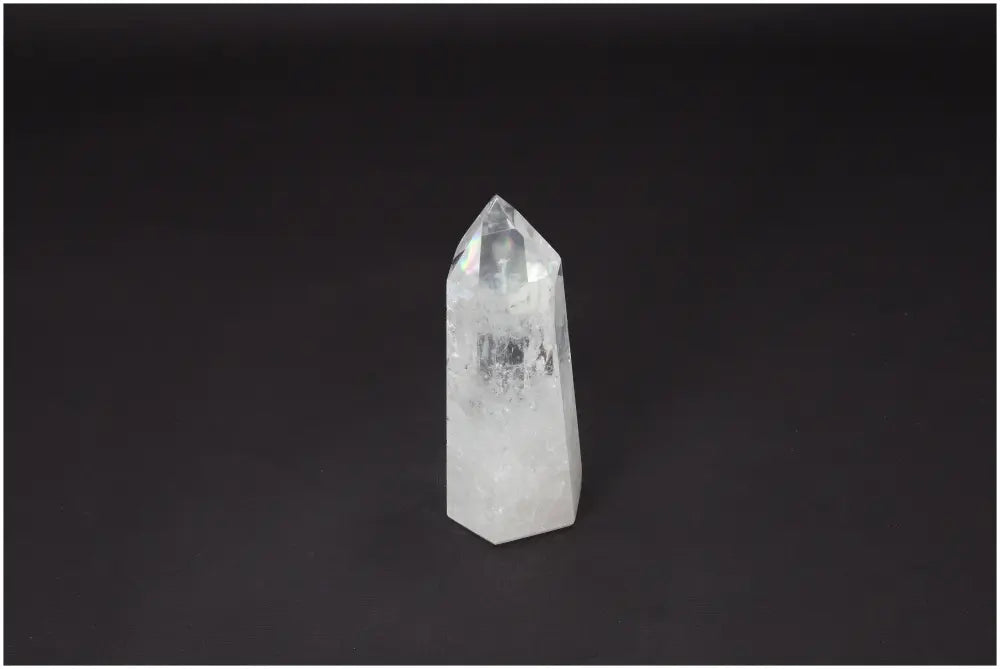 Lemurian Quartz Obelisk on dark background, clear crystal known for healing and personal growth, ethically sourced and hand-selected.