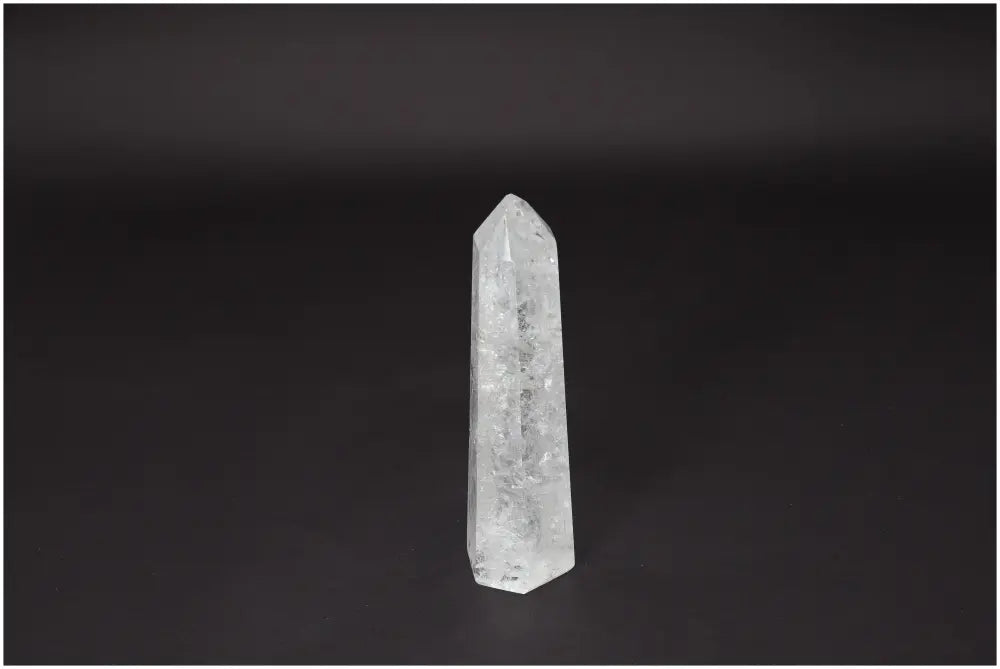Lemurian Quartz Obelisk - clear quartz crystal for clarity, balance, and personal growth on a dark background.