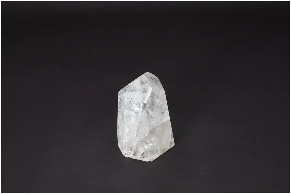 Lemurian Quartz Obelisk on a dark background, showcasing its clear, naturally formed crystal structure for energy amplification and healing.