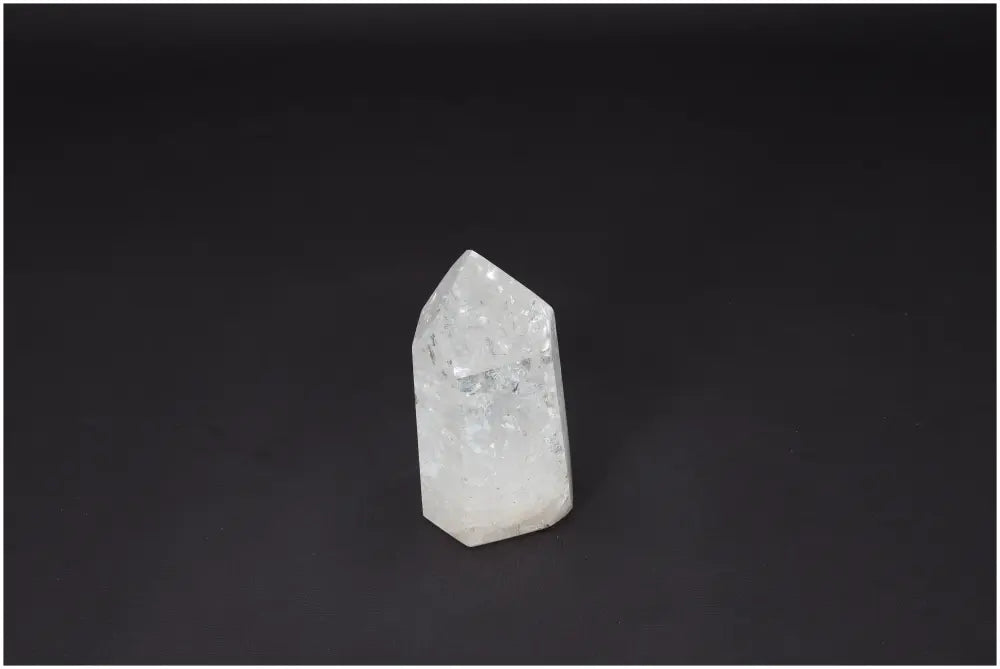 Lemurian Quartz Obelisk against a dark background, known as the "Master Healer," enhances clarity and balance. Ethically sourced crystal.