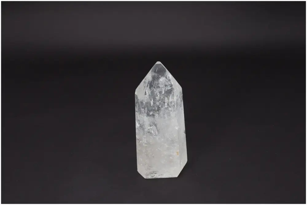 Lemurian Quartz Obelisk on black background, a Clear Quartz crystal known for clarity and energy amplification, ethically sourced and hand-selected.