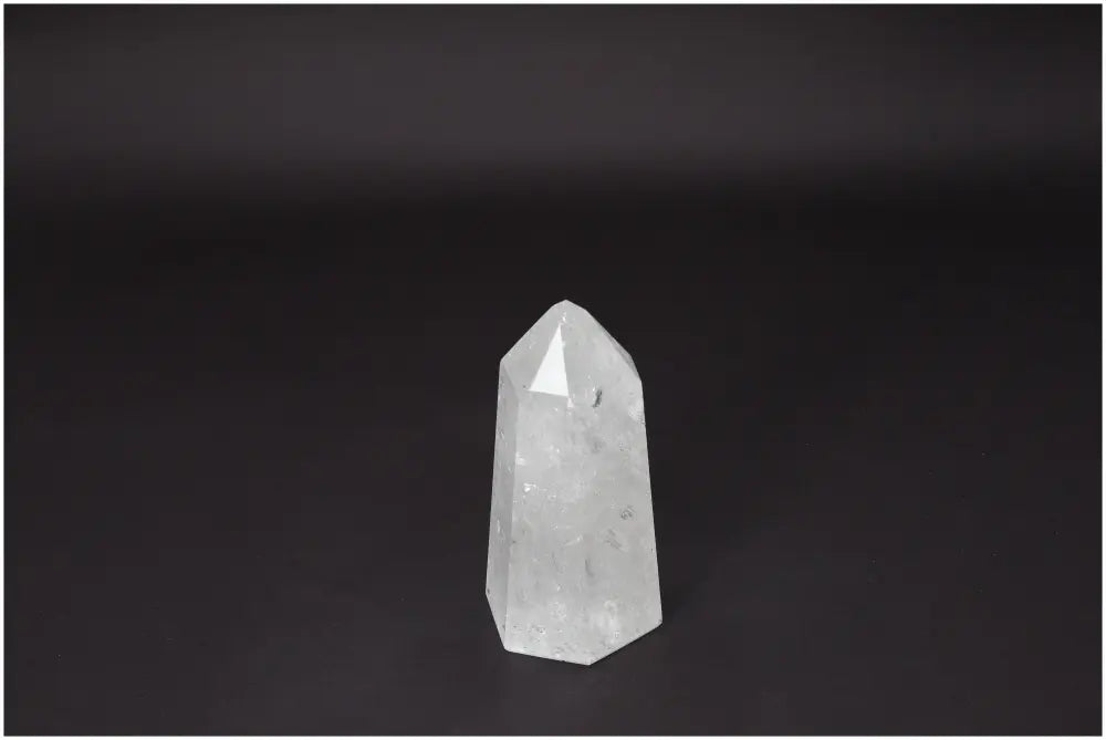 Lemurian Quartz Obelisk on dark background, showcasing clear crystal clarity and natural formation, ideal for energy amplification and healing.