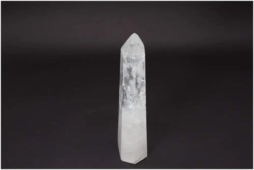 Lemurian Quartz Obelisk against a dark background, showcasing its natural clarity and crystalline structure.