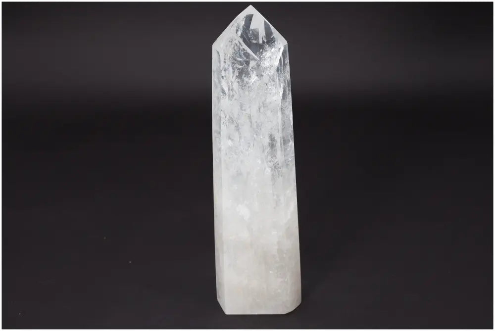 Lemurian Quartz Obelisk crystal on black background, known as the "Master Healer," amplifying energy and promoting balance.