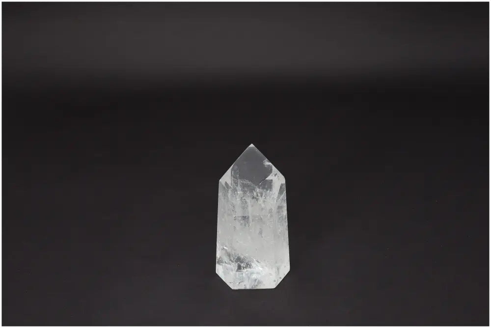 Lemurian Quartz Obelisk against a dark background, showcasing its clear, naturally formed crystal structure for clarity and balance.