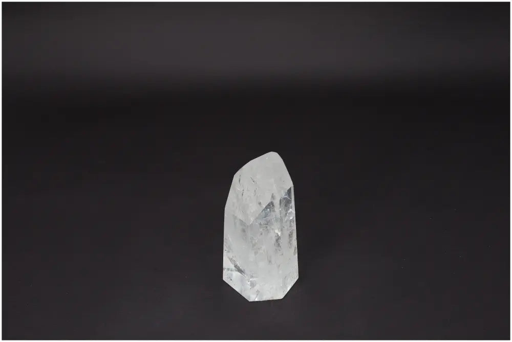 Lemurian Quartz Obelisk on dark background, amplifying clarity and balance. Ethically sourced, naturally formed crystal.
