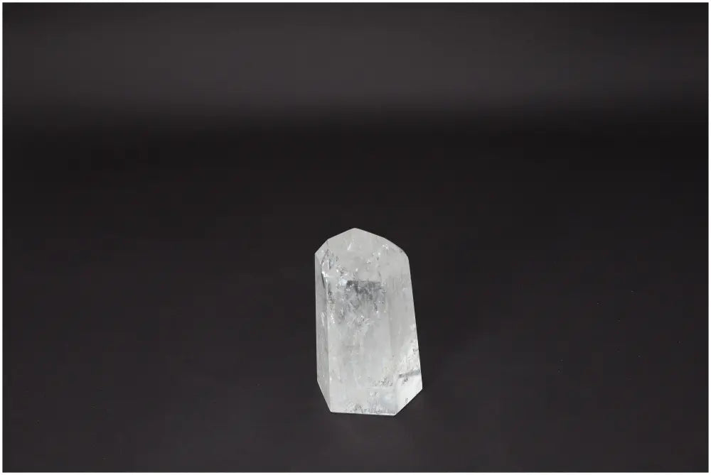 Lemurian Quartz Obelisk on dark background, showcasing its natural clarity and healing properties for energy and emotional balance.
