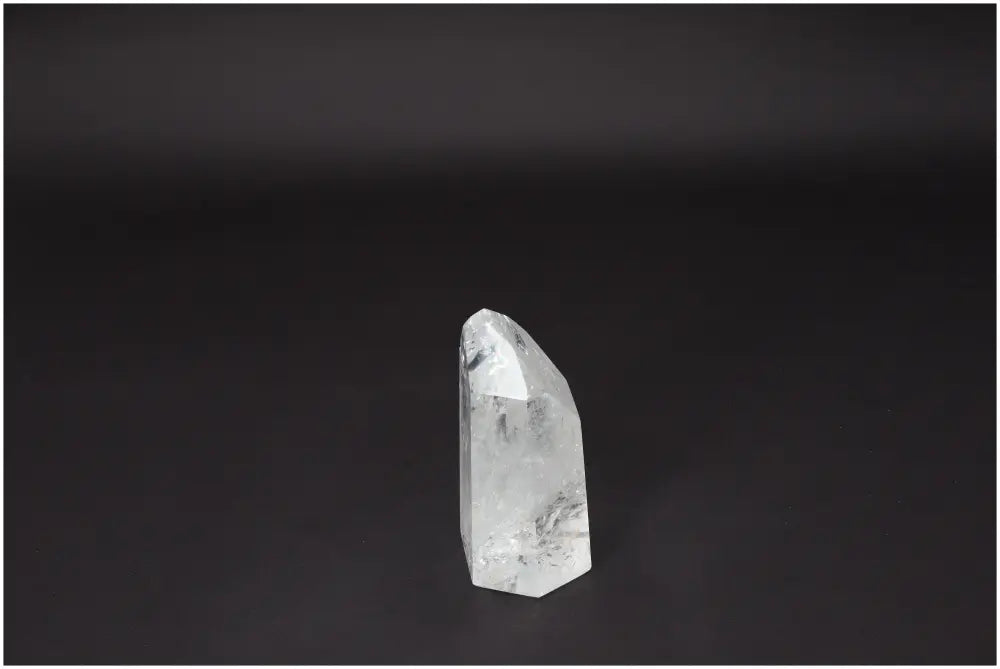 Clear Lemurian Quartz Obelisk against a dark background, symbolizing clarity, balance, and personal growth. Ethically sourced crystal.