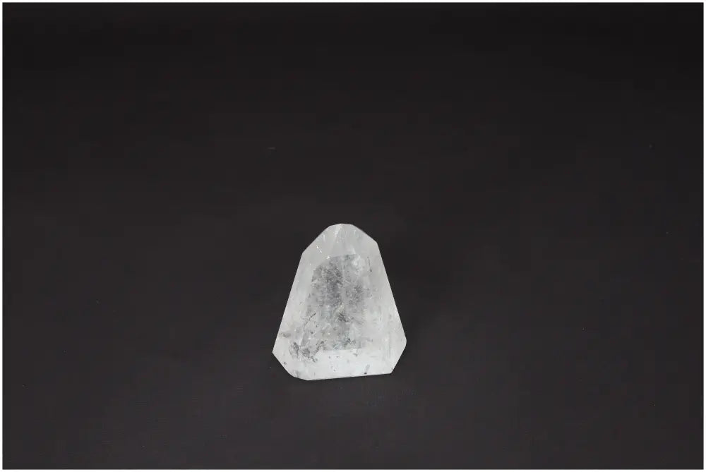 Clear Quartz Lemurian Obelisk on dark background, ethically sourced for clarity and balance, known as "Master Healer" crystal.