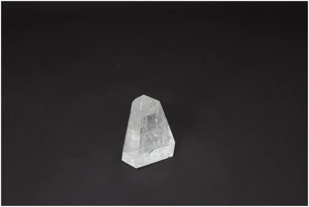 Lemurian Quartz Obelisk on black background, clear crystal used for clarity and healing, hand-selected and ethically sourced.