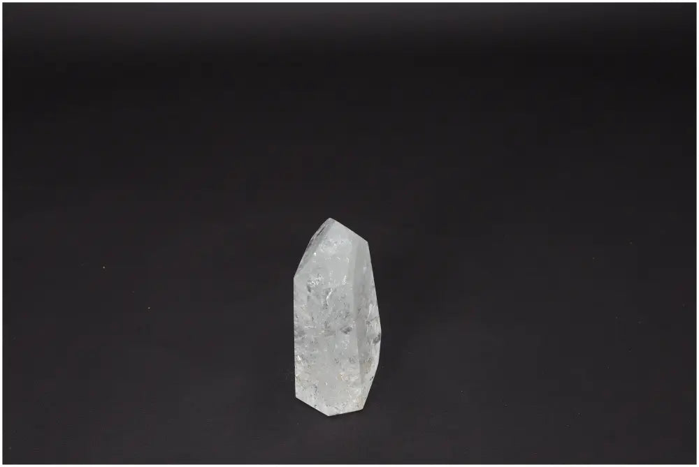 Lemurian Quartz Obelisk on dark background, known as a "Master Healer," enhances clarity, balance, and personal growth.