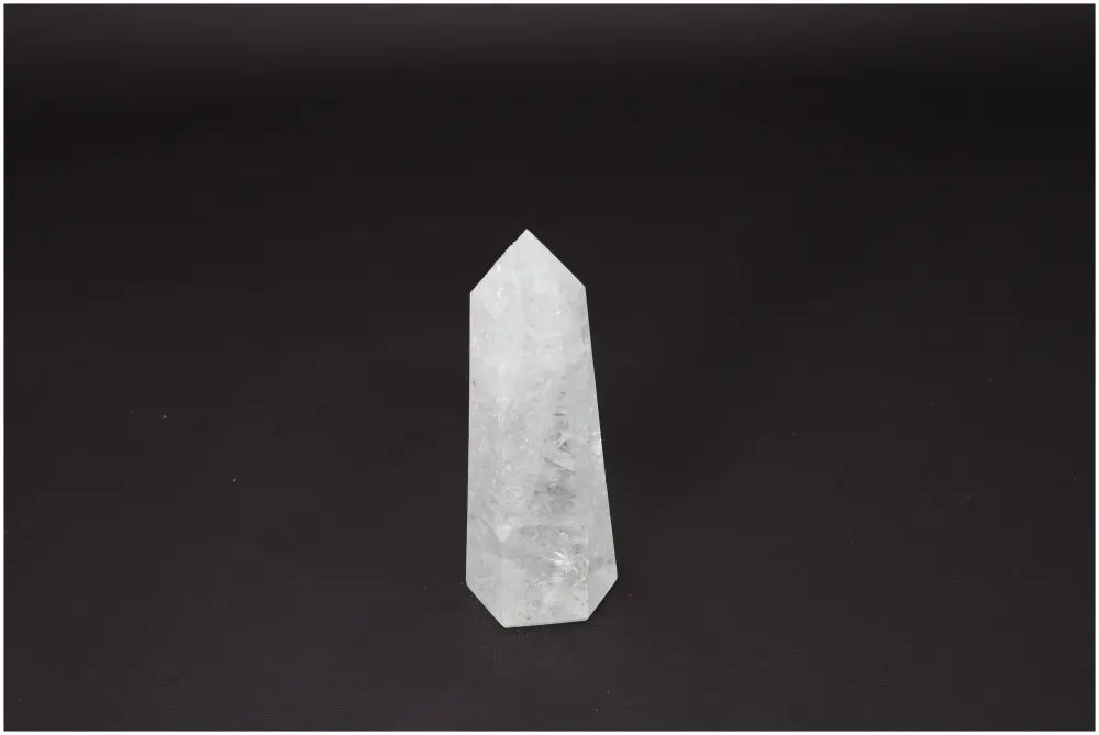 Lemurian Quartz Obelisk on a dark background, known for clarity and healing properties, ethically sourced and hand-selected.