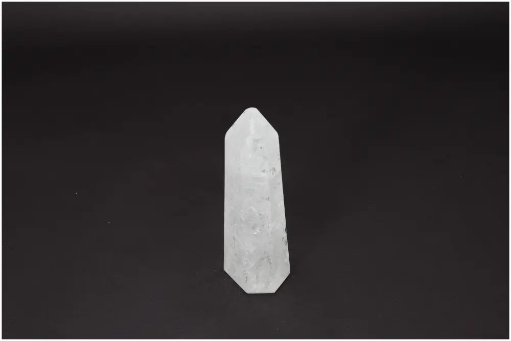 Lemurian Quartz Obelisk on dark background, showcasing its crystal clarity and natural formation. Ideal for energy amplification and healing.