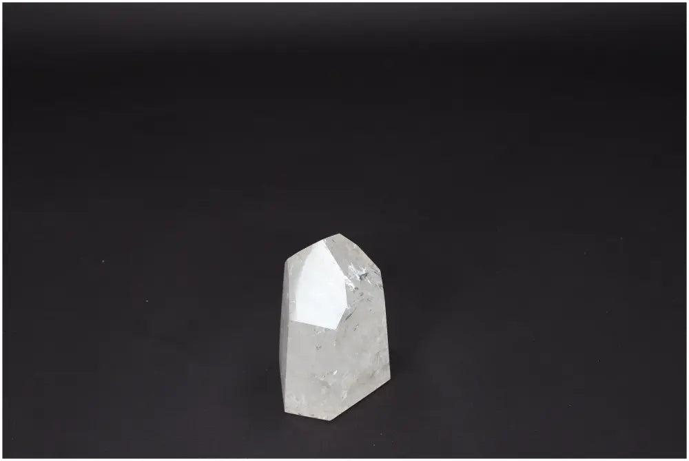 Lemurian Quartz Obelisk on a dark background, showcasing its clarity and natural form, ideal for energy amplification and personal growth.