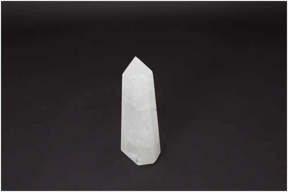Lemurian Quartz Obelisk crystal against dark background, emphasizing clarity and balance for personal growth and energy amplification.