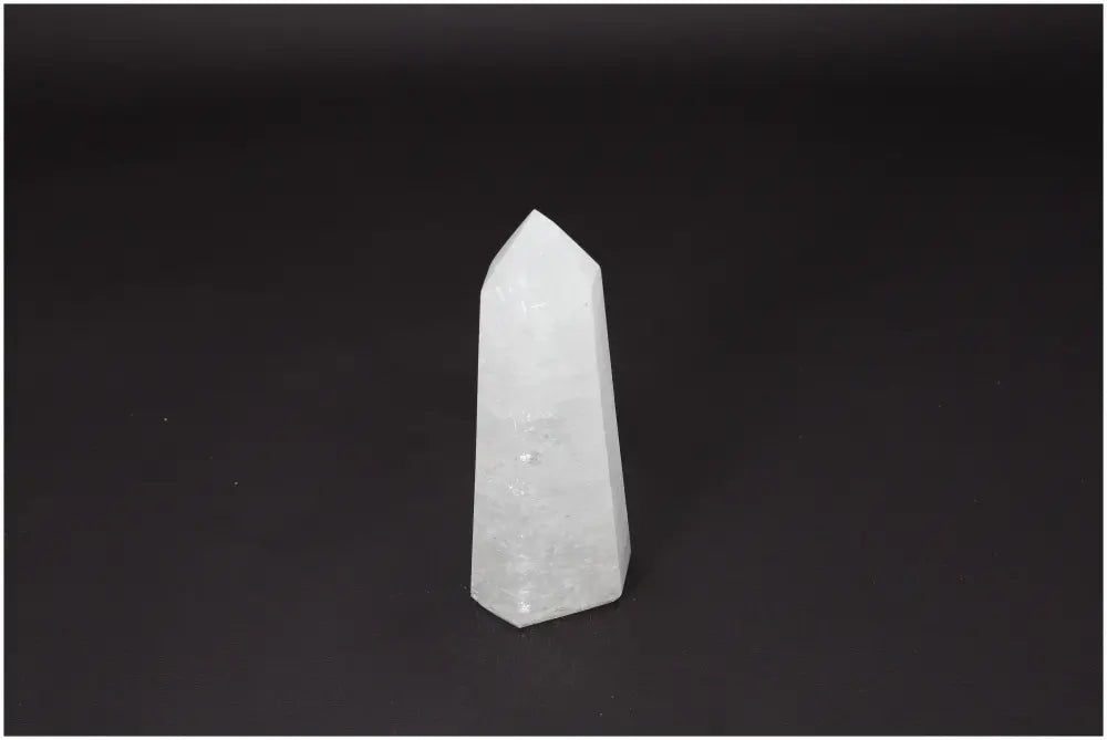 Lemurian Quartz Obelisk on black background, clear crystal for clarity and balance, ethically sourced and naturally formed.
