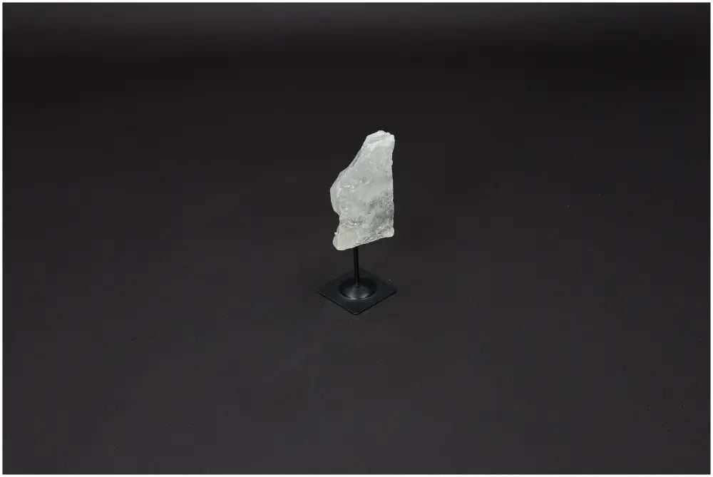 Lemurian Quartz on metal stand against dark background, highlighting crystal clarity and elegance for personal growth and balance.