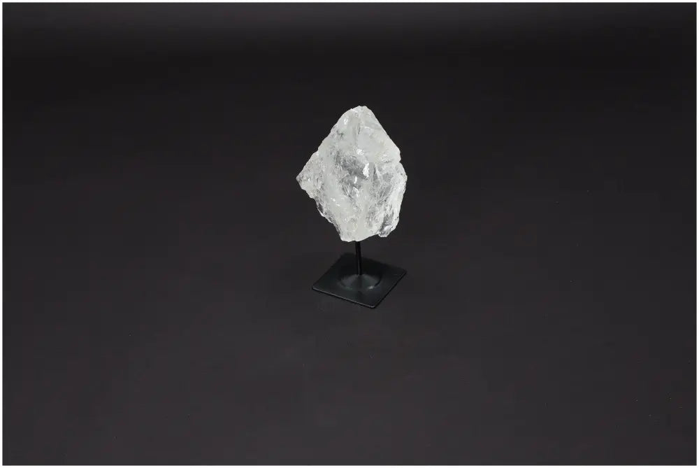 Lemurian quartz crystal on a metal stand, known for clarity, balance, and energy amplification.