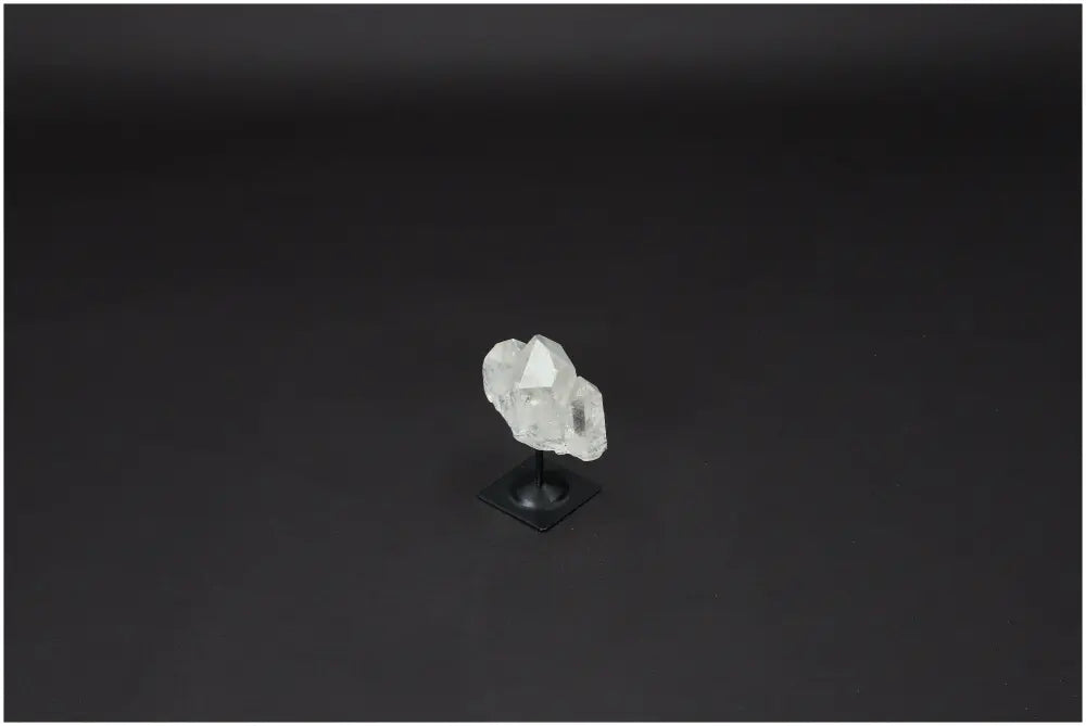 Lemurian Quartz on a stylish metal stand against a dark background, ideal for energy amplification and personal growth.