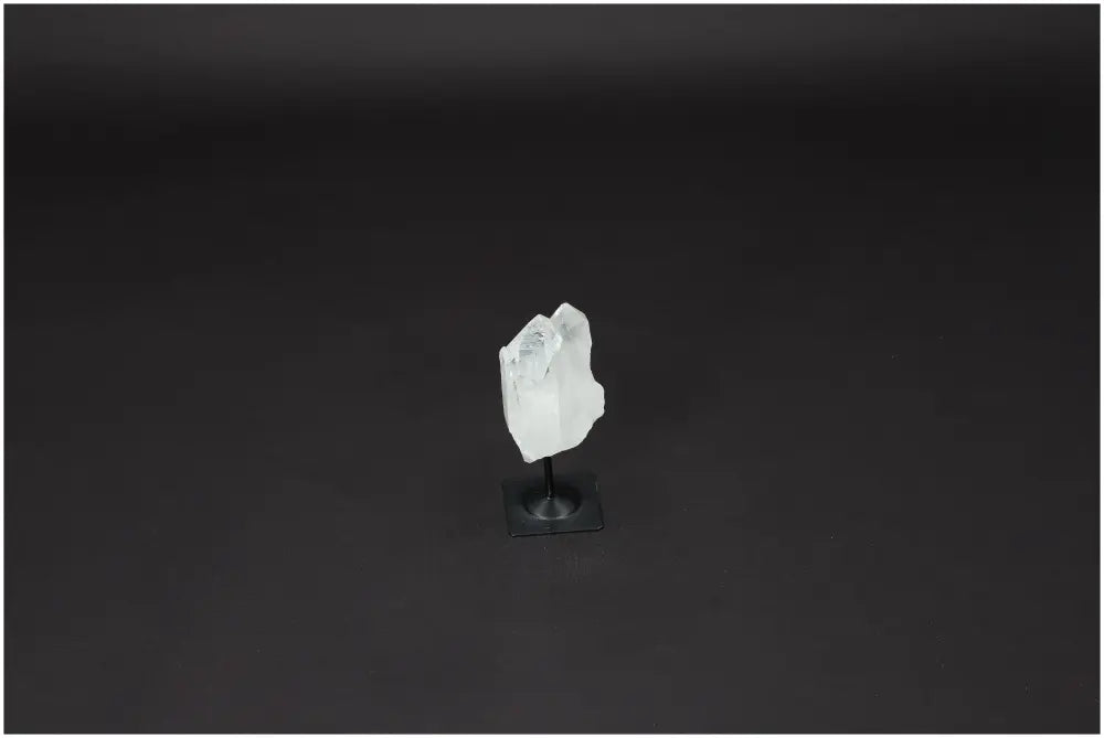 Lemurian Quartz crystal on a metal stand, promoting clarity and balance, known as the "Master Healer" in the crystal world.