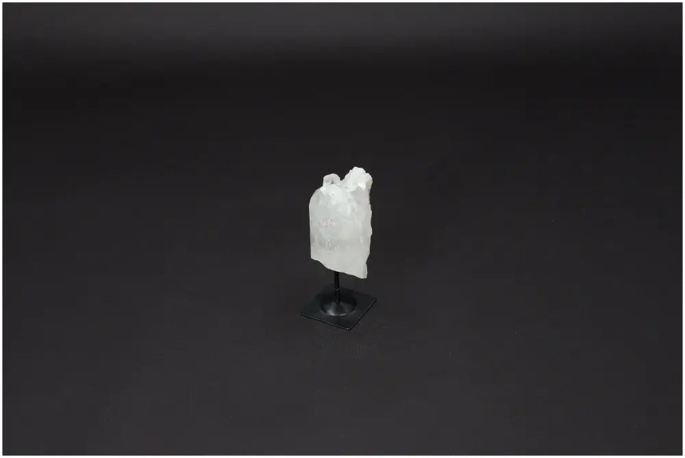 Lemurian Quartz crystal on metal stand against dark background, symbolizing clarity and personal growth.