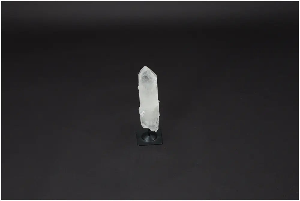 Lemurian Quartz crystal on metal stand against black background, promoting clarity and balance as a powerful "Master Healer."