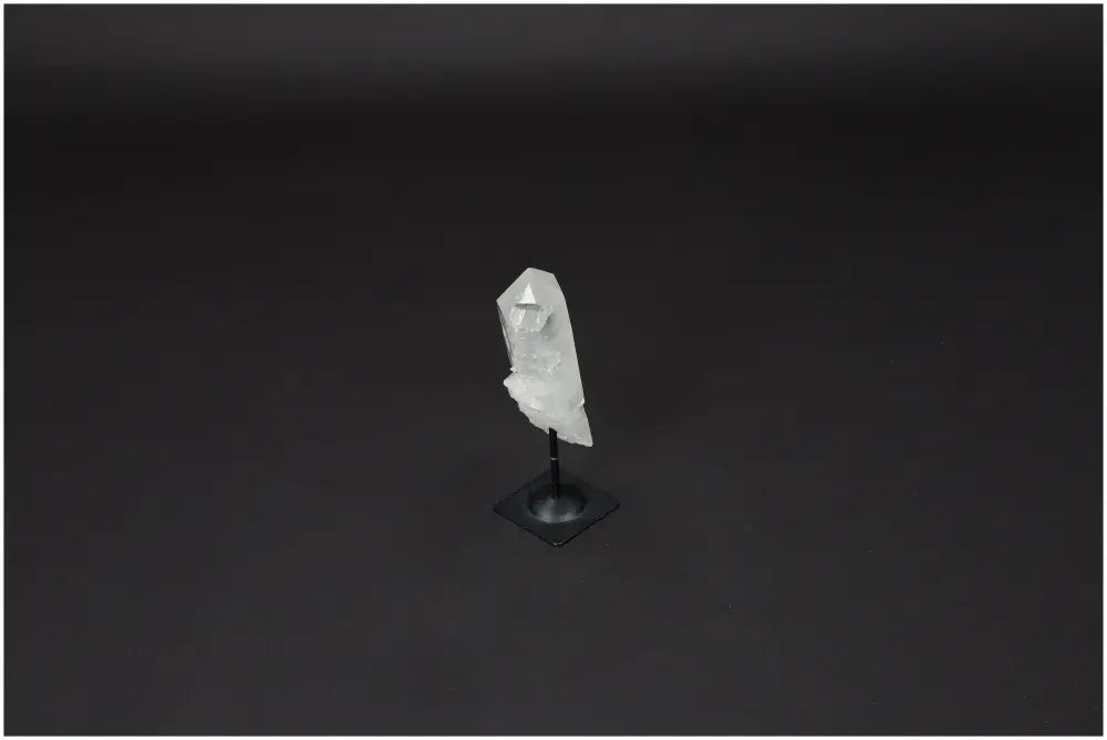 Lemurian Quartz crystal on a metal stand against a dark background, symbolizing clarity, balance, and personal growth.