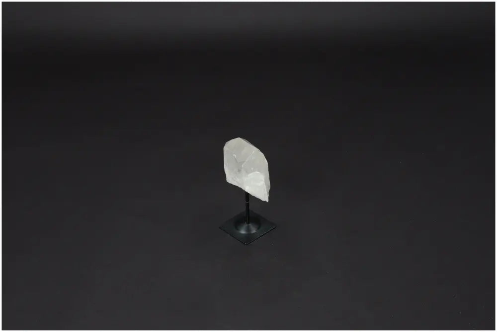 Lemurian Quartz crystal on a metal stand against a dark background, ideal for clarity and emotional balance.