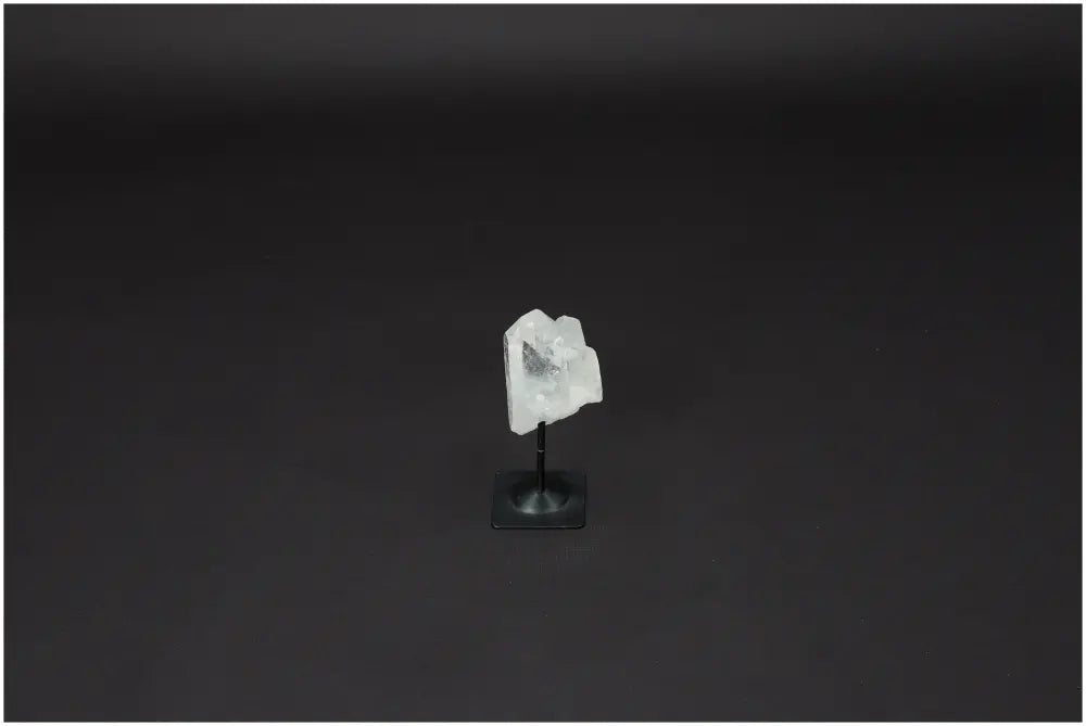 Lemurian Quartz crystal on a metal stand, ideal for energy amplification and personal growth, displayed on a dark background.