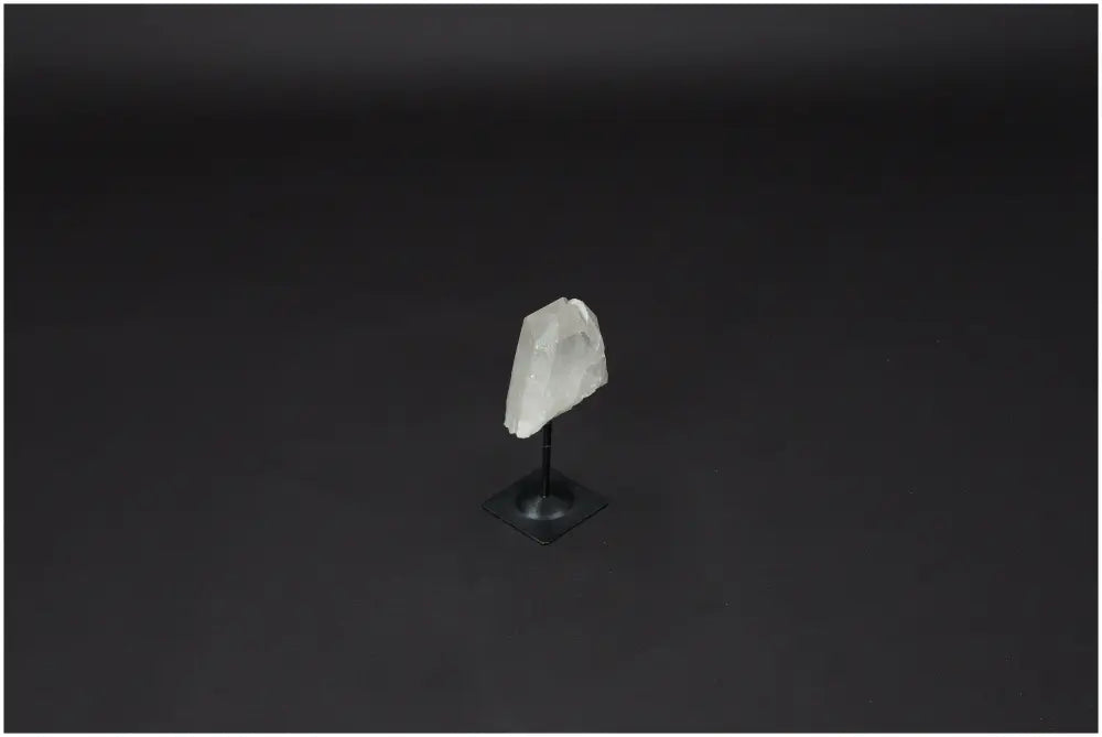 Lemurian Quartz crystal on a metal stand, symbolizing clarity and balance, known as the 'Master Healer' in the crystal world.