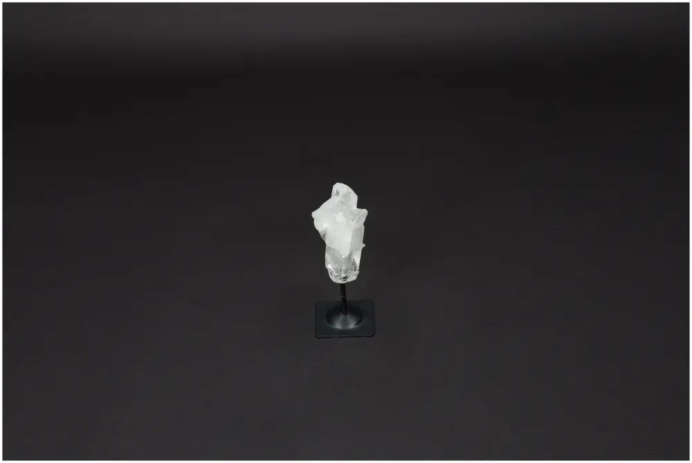 Lemurian Quartz crystal on a metal stand, known for clarity and balance, hand-selected and ethically sourced.