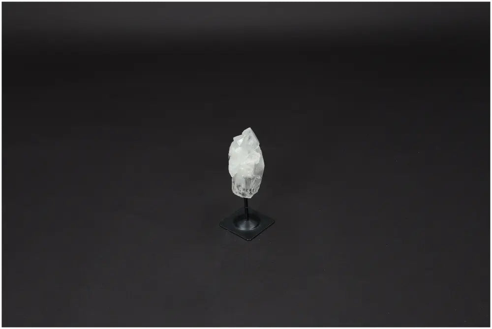 Lemurian Quartz crystal on a metal stand, known as a "Master Healer," enhancing clarity and balance, ethereal beauty.