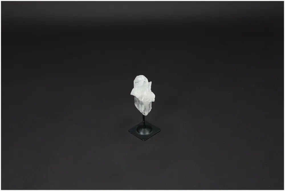 Lemurian Quartz crystal on metal stand, known for amplifying energy and promoting clarity, balance, and personal growth.