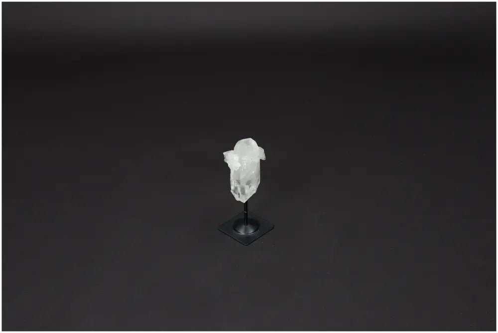 Lemurian Quartz crystal displayed on a sleek metal stand, known for clarity and energy amplification. Ethically sourced and hand-selected.