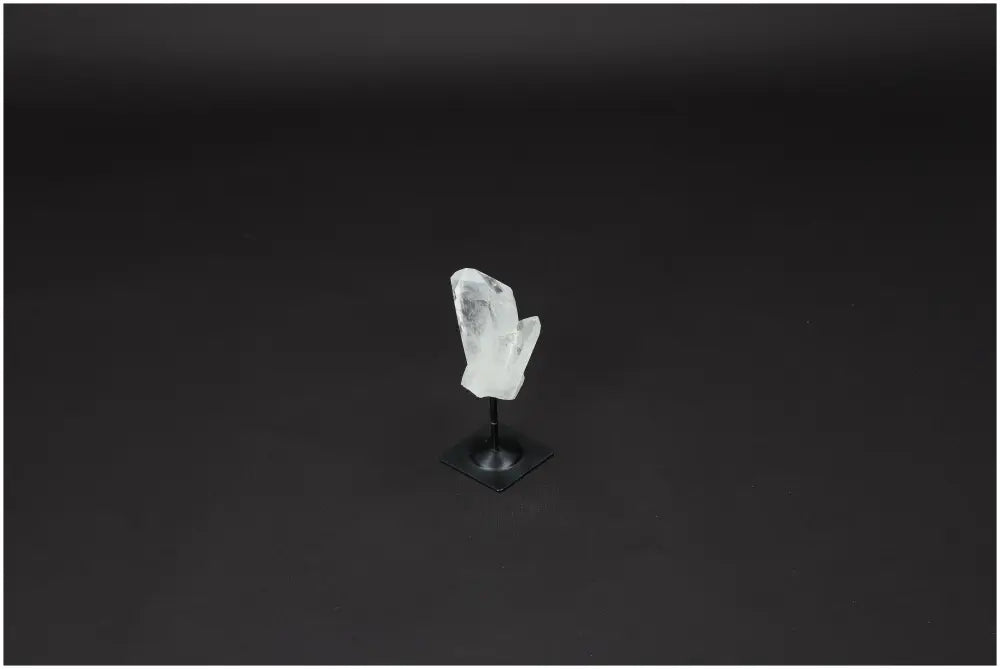 Lemurian Quartz on metal stand against dark background, known for purification and neutralizing negative energies, ideal for daily use.