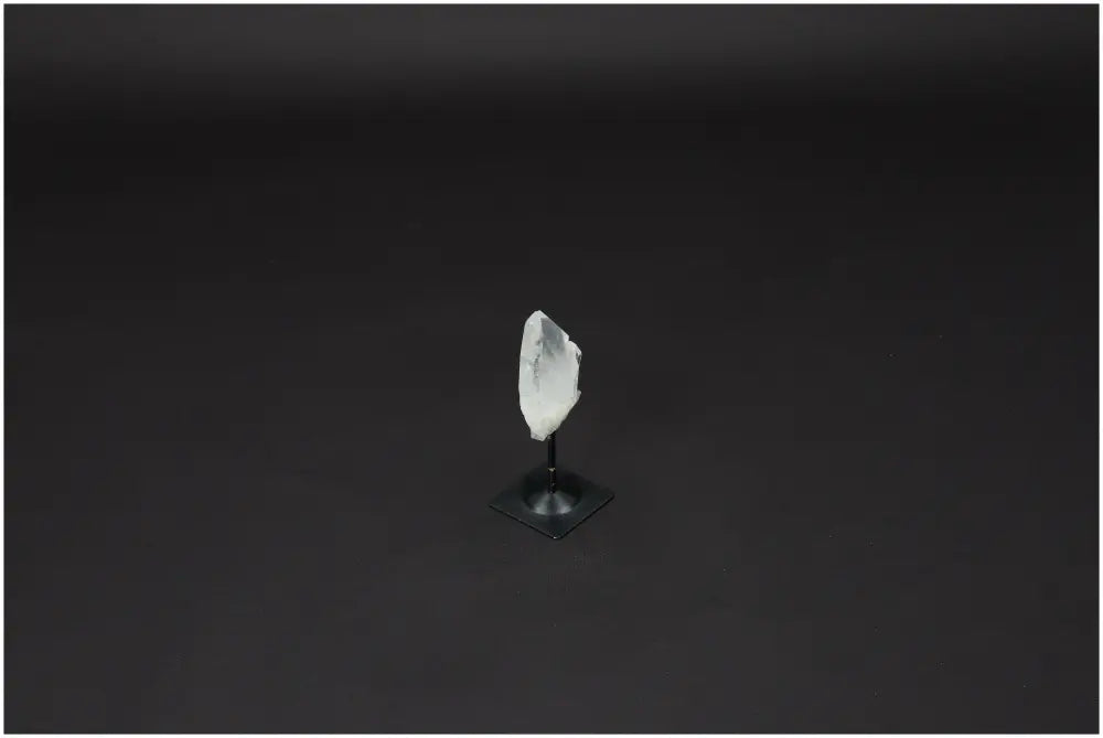 Lemurian Quartz Crystal on black metal stand, known as 'Master Healer' for clarity and balance, used for energy amplification.