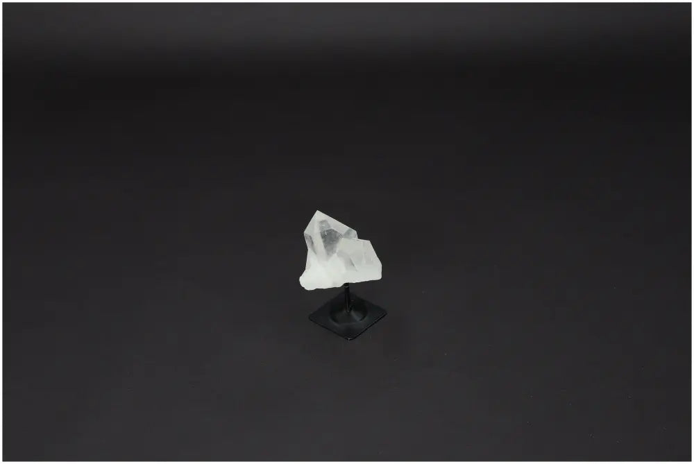 Lemurian Clear Quartz on metal stand used for purification and neutralizing negative energy, ideal for harmonizing body and mind.