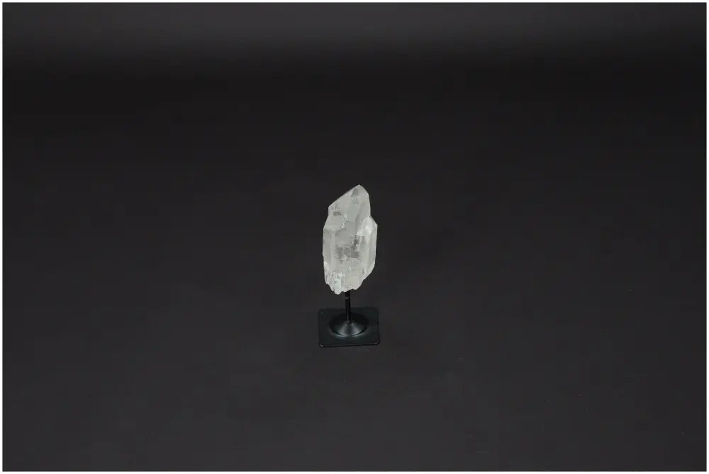 Lemurian Quartz on a metal stand, showcasing its clear, powerful purification properties against negative vibrations.